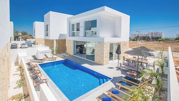 A modern two-story house with a swimming pool, outdoor seating, and a view of the surrounding area. - Vie Bleu 1 - Four Bedroom Villa, Sleeps 8 (Πρωταράς)