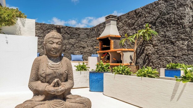 A Buddha statue in a meditative pose, a stone wall, and a traditional wood-fired oven. - Villa Samui - Four Bedroom Villa, Sleeps 8 (Playa Blanca)