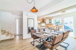 Enjoy family meals and gatherings in the spacious dining area with a large table and comfortable seating.