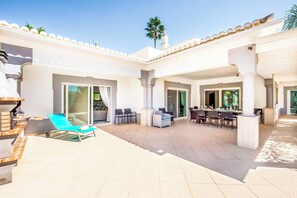 Relax outdoors with a barbecue grill, sun lounger, and comfortable seating for dining or socializing.