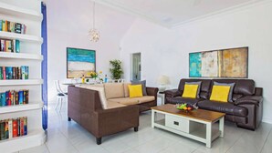 A living room with a sofa, coffee table, and bookshelf.