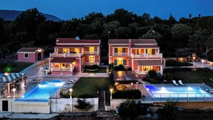 A large, two-story building with a swimming pool and outdoor seating area. - Villa Mirela Mikri - Three Bedroom Villa, Sleeps 6 (Corfu)