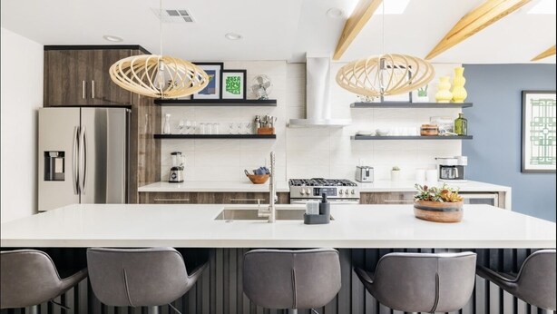 A modern kitchen with a central island, stainless steel appliances, and wooden accents. - Retro Mid-Mod Vibes Getaway (Centrally Located) (Phoenix)
