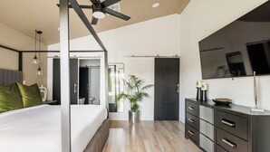 A modern bedroom with a bed, bedside table, and a large mirror. - Retro Mid-Mod Vibes Getaway (Centrally Located) (Phoenix)