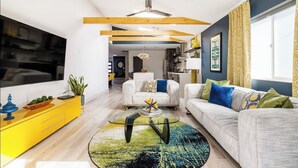 A modern living room with a sofa, coffee table, and yellow sideboard. - Retro Mid-Mod Vibes Getaway (Centrally Located) (Phoenix)