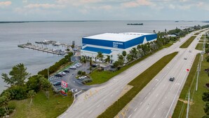 A marina bar & grill with a parking lot and a road leading to it. - New and sparkly 2/1 on 4 acres! (Sebastian)