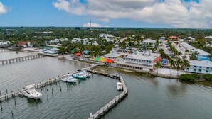 A marina with boats docked, a pier, and buildings with colorful roofs. - New and sparkly 2/1 on 4 acres! (Sebastian)