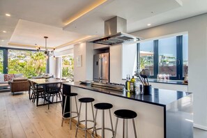 Enjoy meals in the kitchen with a sleek island, bar stools, and ample counter space, offering views of the surrounding area.
