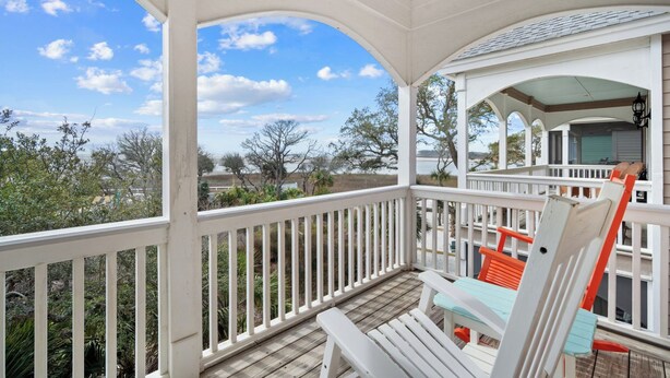 A covered porch with white railings, a wooden deck, and a view of the surrounding landscape. - Great views, close to cabana club, golf cart included - 23 Veranda Beach (Fripp Island)