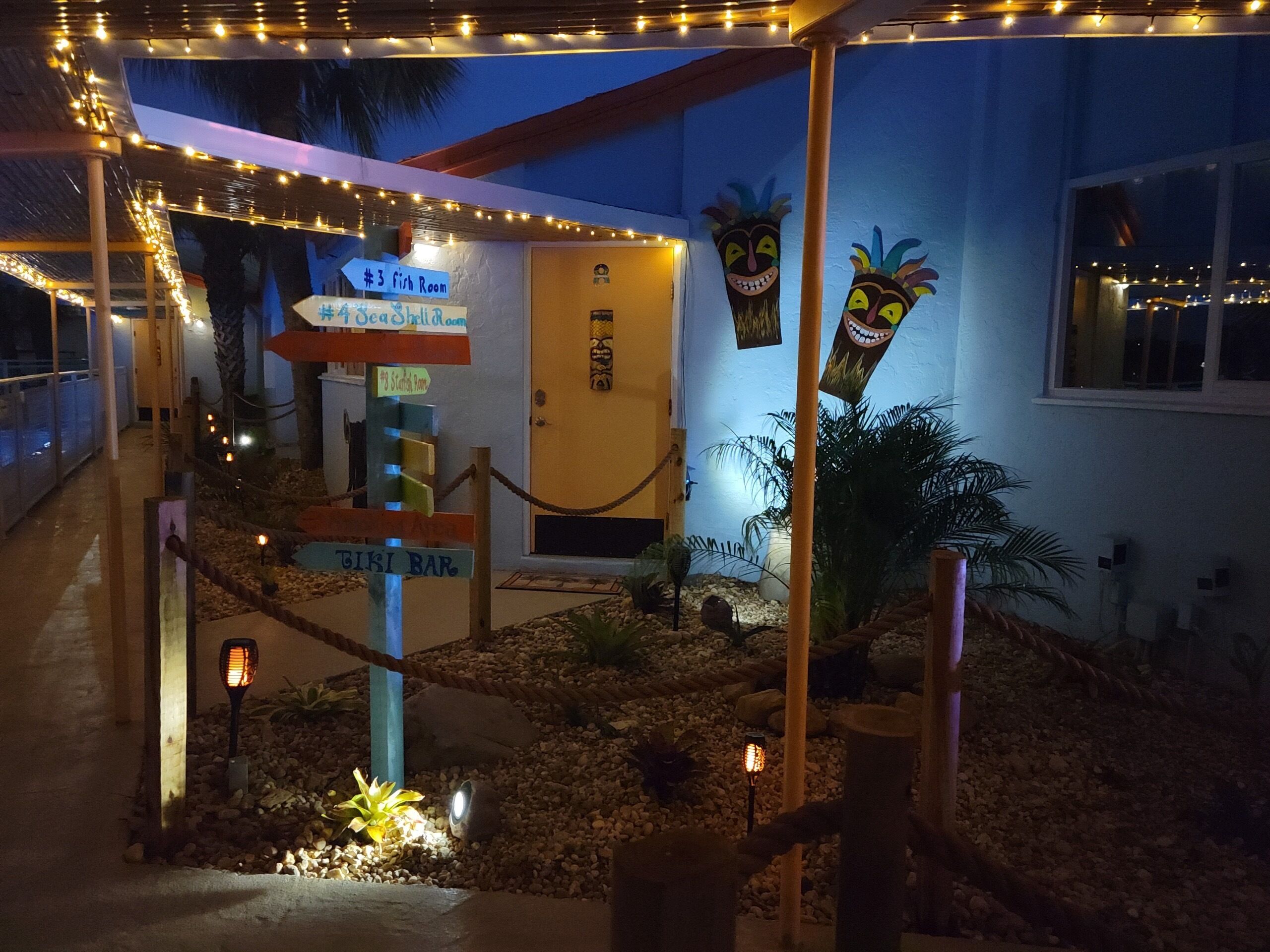 A building entrance with a sign for the #3 Fish Room, a tiki bar, and a door labeled "Tiki Bar."