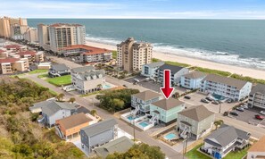An aerial view of a coastal residential area with a hotel featuring a pool and a view of the beach. - Just Coasting - Saltwater Pool, 5 Bedrooms, Across Street to Beach (North Myrtle Beach)
