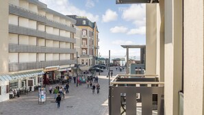A public square with a modern building, shops, and a covered area. - Exklusiv. Strandnah. Zentral (Westerland)