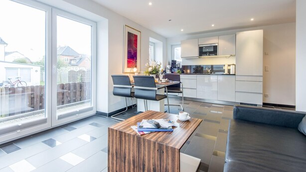 A modern kitchen with white cabinets and a microwave. - Hell. Entspannend. Komfortabel (Westerland)