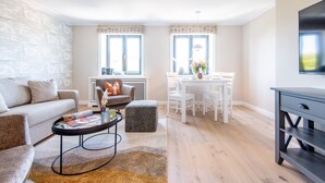 A modern living room with a sofa, coffee table, and dining area. - Stadthaus Boysenstraße, Whg. 7 Ruhig. Gemütlich. Strandnah. Objekt-id: Shb/07 (Westerland)