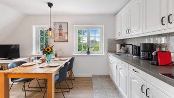 Fridge, stovetop, dishwasher, coffee/tea maker