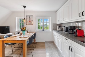 Fridge, stovetop, dishwasher, coffee/tea maker