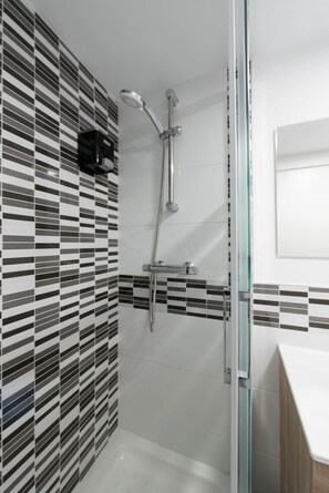 Shower, hair dryer, towels, soap