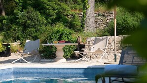 A pool area with lounge chairs and a table with fruit and drinks. - Villa del Mar - LUXURY VILLA with POOL & GARDEN (Rogac, Solta)