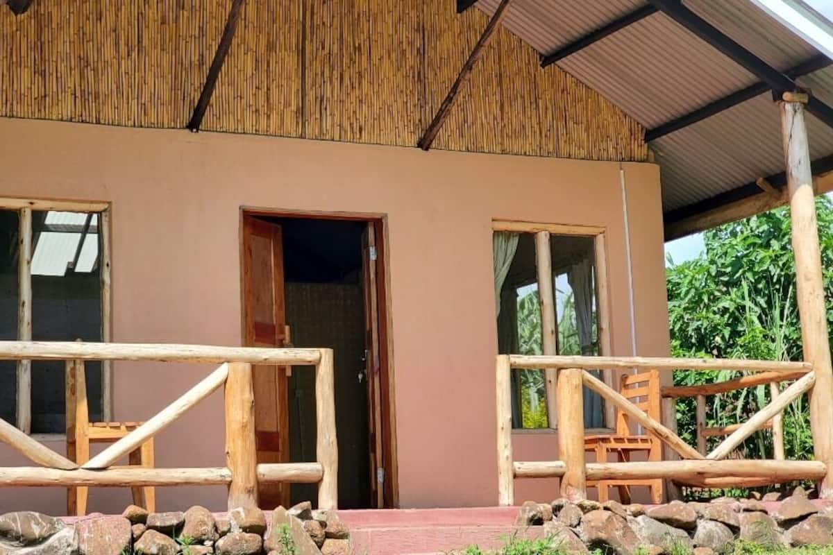 A rustic building with a wooden exterior, a covered porch, and a simple entrance.