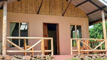 A rustic building with a wooden exterior, a covered porch, and a simple entrance.