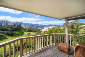A balcony with a view of a golf course, mountains, and a lake. - Magical views of Hanalei Bay, Napali Coast and the Makai Golf Course in a beautifully styled home (Princeville)