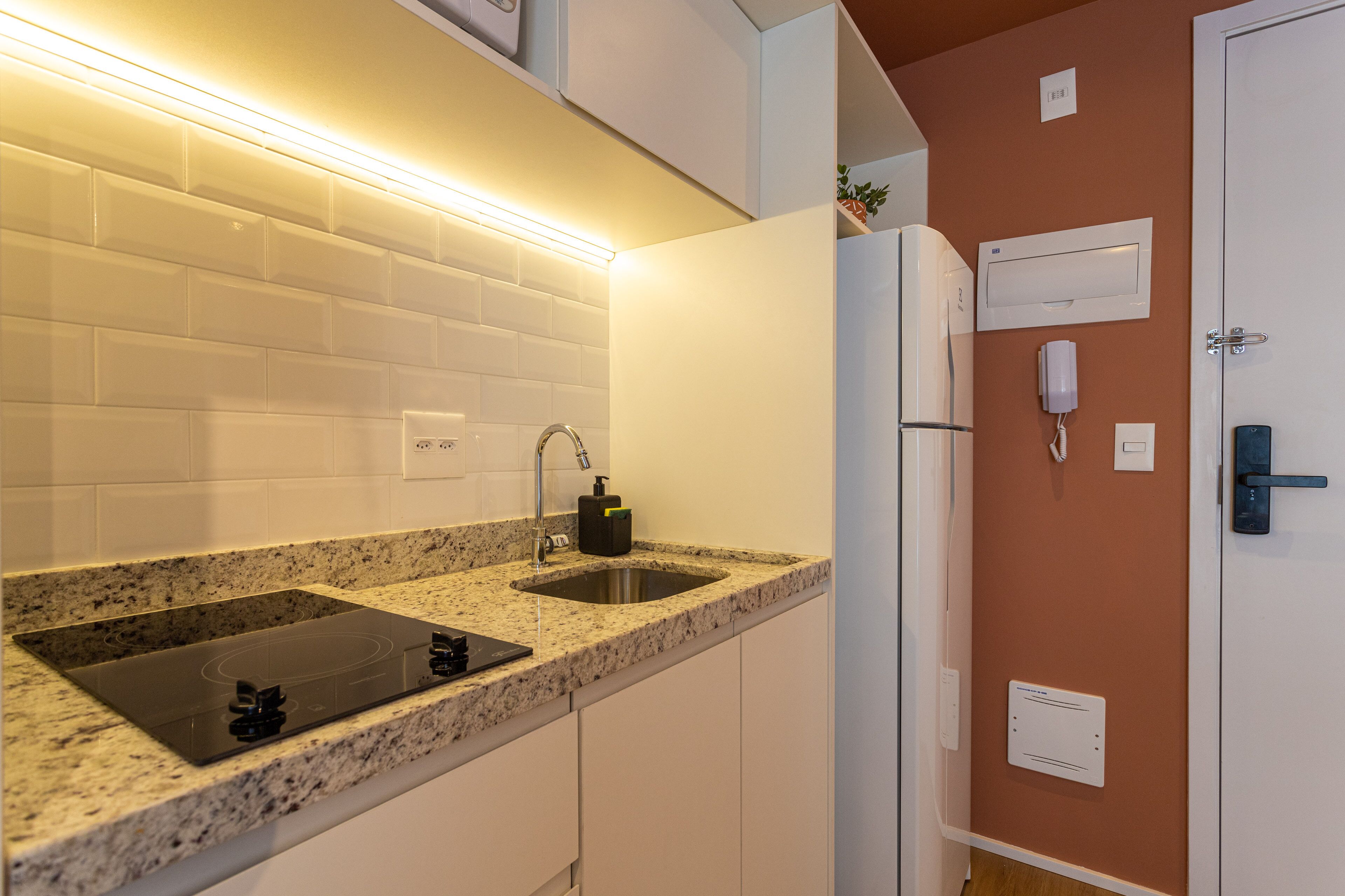 A modern kitchen with granite countertops, a double sink, and stainless steel appliances.