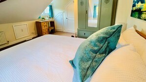 A bedroom with a large bed, a wardrobe, a desk, and a window with curtains. - Central Bristol/Bath both 9 mins by train - by river, park in Conservation Area (Keynsham)