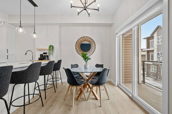 Dining area with seating for 4 at the table, and 4 at the island.