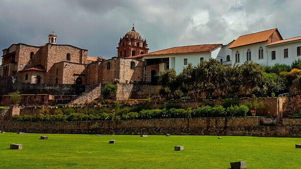 A historic building complex with a church, a bell tower, and a white building with a red roof. - PRIVATE APART WITH AMAZING VIEW OF CUSCO (Cusco)