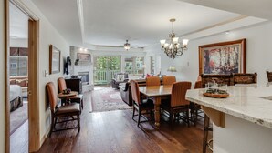A spacious dining area with a large wooden table and chairs, a chandelier, and a view of the outdoors. - Luxurious 3 bedroom 3 bath condo! 3 Condo by RedAwning (Avon)