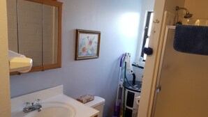 A bathroom with a sink, toilet, and shower. - Quite studio with RV parking (Lake Havasu City)