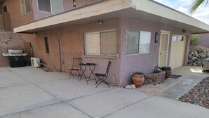 A two-story house with a covered patio area. - Quite studio with RV parking (Lake Havasu City)