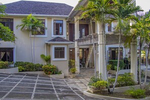 Stunning two-story building with a central entrance and lush surroundings.