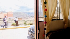 A room with a view of a mountainous landscape through a window with yellow curtains. - COZY & BEAUTIFUL APART IN SAN BLAS CUSCO (Cusco)