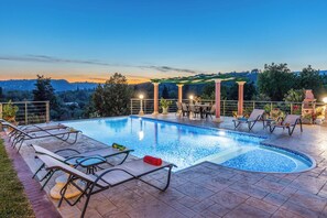 A swimming pool with lounge chairs and a pergola, surrounded by a fence and trees. - Villa Mirela Megali - Four Bedroom Villa, Sleeps 9 (Corfu)