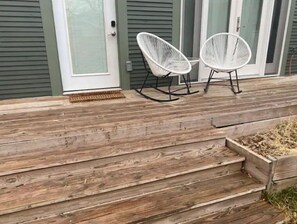 Guests can sit in the rocking chairs on the outdoor deck.