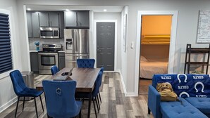 A modern apartment with a dining area, kitchen, and living room. - Newly Rennovated Home next to Zoo and Downtown Stadiums (Indianapolis)