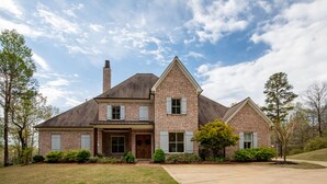A two-story brick house with a gabled roof, a chimney, and a front porch. - Spacious, serene retreat perfect for Oxford visits<br>New listing!!  (Oxford)