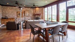 A spacious room with a large dining table, wicker furniture, and a fireplace. - Spacious, serene retreat perfect for Oxford visits<br>New listing!!  (Oxford)