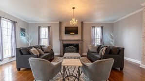 A living room with two sofas, a coffee table, and a fireplace.