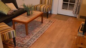 A living room with a sofa, armchairs, a coffee table, and a patterned rug. - Slopeside. Buy your ski/snowboard tickets on line! (Big Bear Lake)