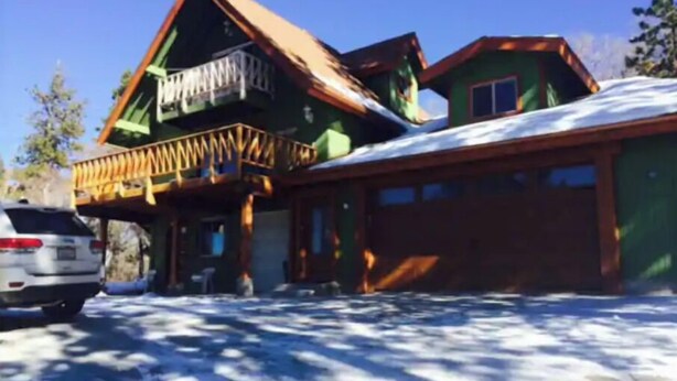 A two-story house with a green roof and a wooden balcony. - Slopeside. Buy your ski/snowboard tickets on line! (Big Bear Lake)