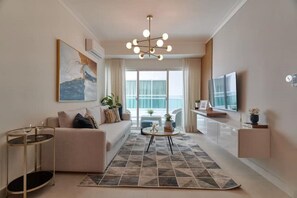 A modern living room with a sofa, coffee table, and artwork on the wall. - 2-ROOM APARTMENT WITH SWIMMING POOL AND GYM   (Santo Domingo)