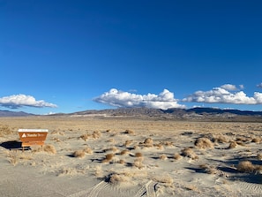 Explore the vast desert landscape with breathtaking views of the surrounding mountains.