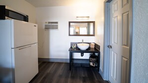 A compact kitchen with a refrigerator, a sink, and a microwave. - OYO Hotel Ocala, Fl I-75 (Ocala)