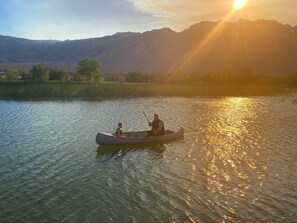 Guests can paddle across the calm waters, surrounded by breathtaking mountain views.