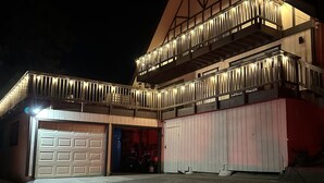 A large, two-story building with a garage and a covered area.