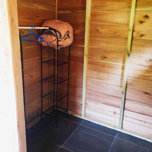 Comfortable room with a metal shelving unit and dark tile flooring.