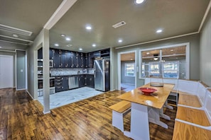 Enjoy cooking in this well-equipped kitchen with a central island, cabinetry, and large window offering a view of the outdoors.