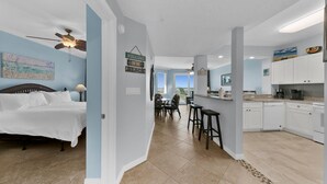 A modern, open-plan living space with a bedroom, dining area, and kitchen. - Remodeled Beachfront 🐠  🦀 Destin West's Best 😎😎 Beach Service Inc ⛱️⛱️NEW EVERYTHING (Fort Walton Beach)